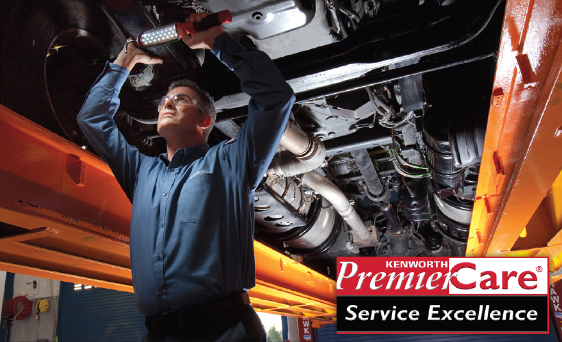 Mechanic working underneath truck promoting Premier Care Service Excellence