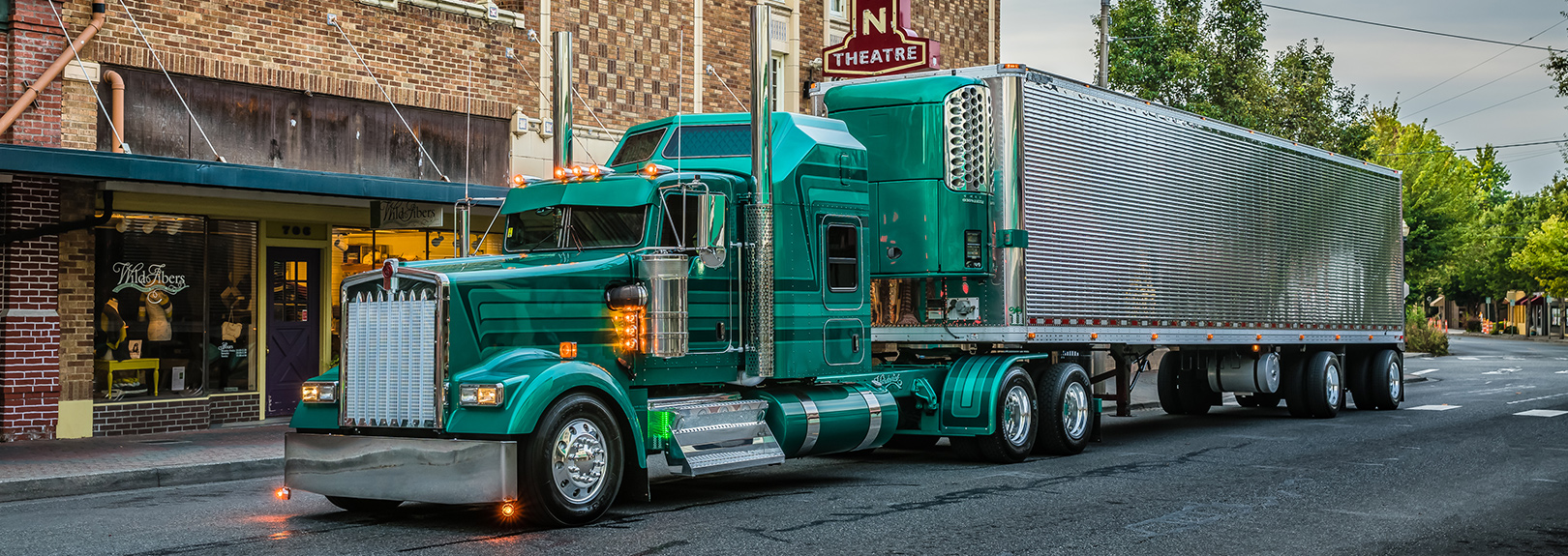 Kenworth W900 truck parked in front of theatre